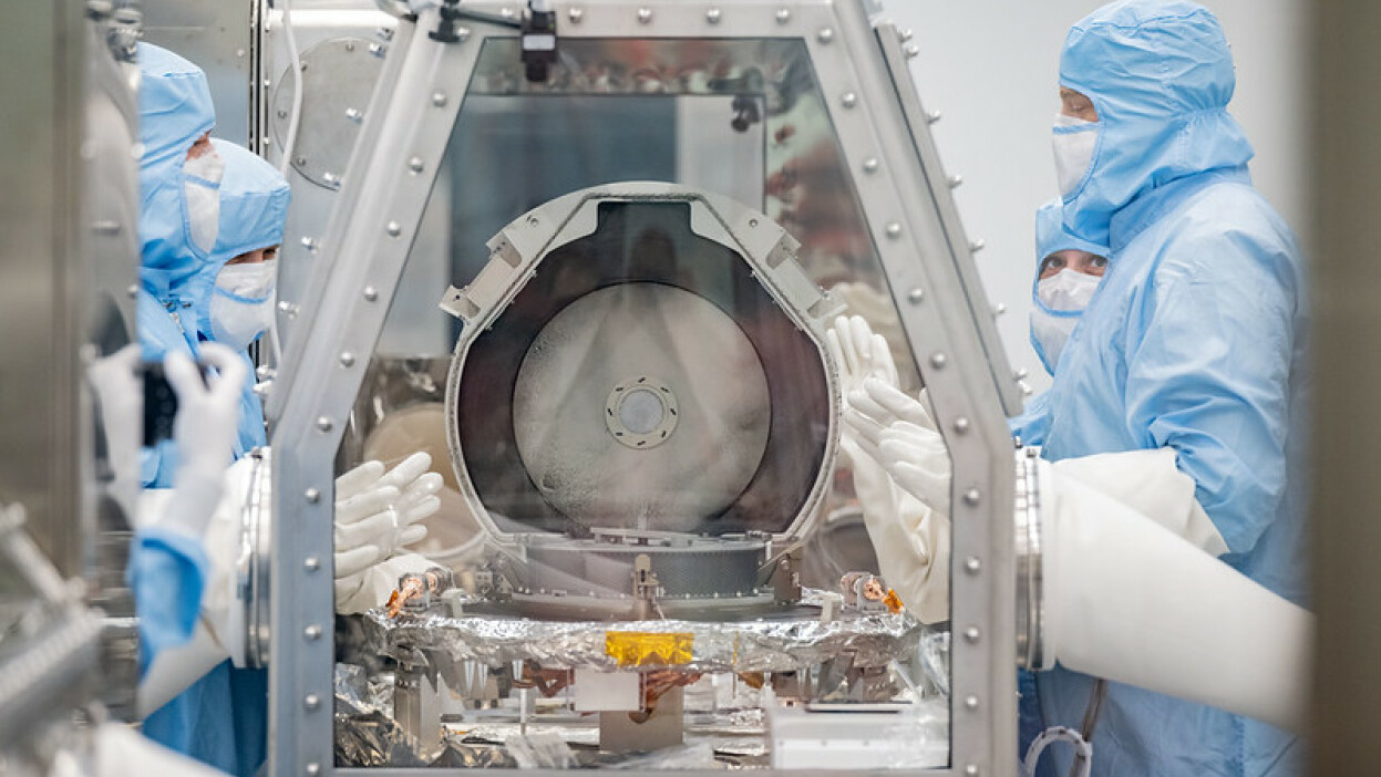 Scientists opening the OSIRIS-REx asteroid sample return lid at the NASA Johnson Space Center 