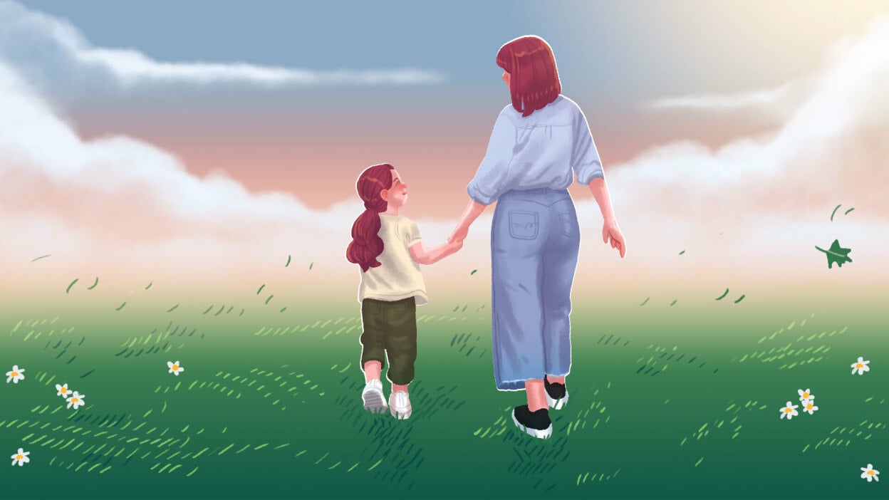 A mother walks hand-in-hand with her daughter.