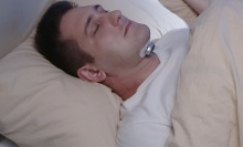Person using the Snore Circle Smart Electronic Muscle Stimulator to sleep.