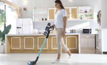 A woman using the JASHEN vacuum to clean her kitchen floors 