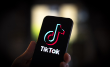 A phone with the TikTok logo displayed on the screen. 