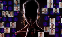 a dimly lit woman making the same "hush" gesture seen in Ashley Madison's marketing materials.