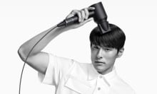 man drying hair with supersonic origin and styling concentrator attachment