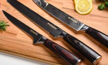 Three Seido knives shown on a cutting board surrounded by lemons and herbs.