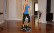 Woman working out on the Stamina InMotion Compact Strider with Cords at home
