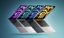 Four 15-inch MacBook Airs lined up artfully over a bluish background