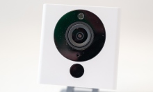 A closeup of a white Wyze webcam.