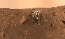 The Curiosity rover covered in dust on Mars.