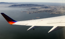 wing of Southwest Airlines plane flying over water