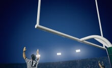 referees signaling a touchdown on football field