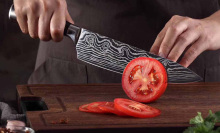 person cutting tomato with Konig knife