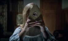 Lulu Wilson looks through a planchet in "Ouija - Origin Of Evil."