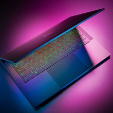 Razer Blade Stealth 13-inch gaming laptop partially closed with RGB keyboard lit up. 