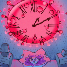 A woman lays in bed staring at a clock that looks like the COVID virus. 