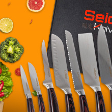 A collection of sharp knives laying on a Seido black gift box, surrounded by images of various vegetables and fruits.