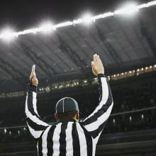 referee signaling a touchdown on football field