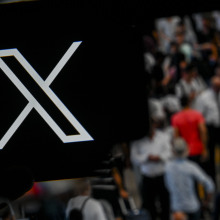 X logo above a crowd