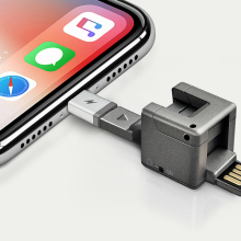 The WonderCube keyring shown connected to an iPhone's charging port