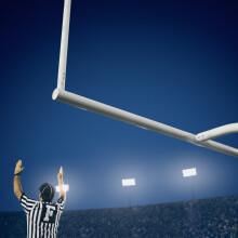 referees signaling a touchdown on football field