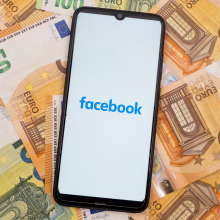 In this photo illustration a Facebook logo seen displayed on a smartphone screen on 50 and 100 Euro bills in Athens, Greece on September 30, 2023.