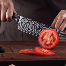 person cutting tomato with Konig knife
