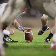 close up of place kick holder position for football