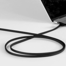 A black, multifunctional charging cable from RollingSquare plugged into a MacBook