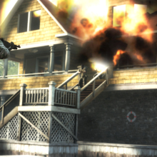 gameplay footage of Counter-Strike showing a player facing a burning yellow house