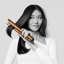 a person uses the dyson corrale hair straightener with the left hand