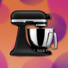 a black kitchenaid mini mixer with a yellow, pink, and purple background