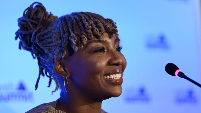 Ayọ Tometi,, Co-founder of Black Lives Matter, smiling during a press conference on day two of Web Summit 2021 at the Altice Arena in Lisbon, Portugal