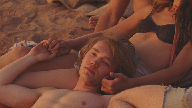 Charlie Plummer and Eve Lindley lie in the sun in "National Anthem."