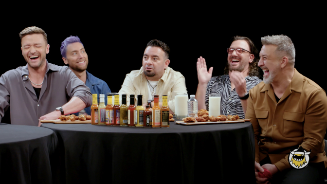 *NSYNC sit being interviewed on the YouTube show "Hot Ones" 