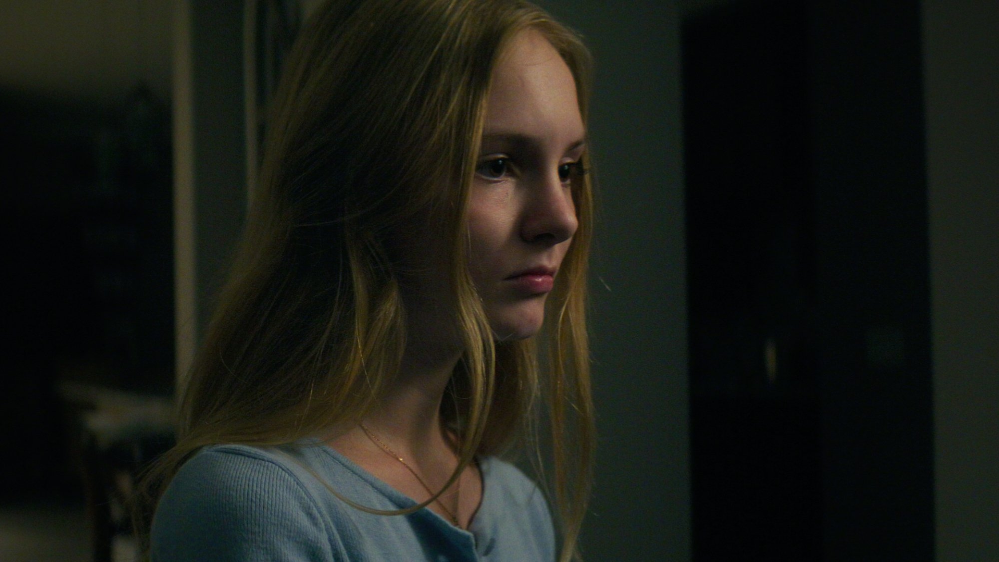 Maya Kowalski sits in a dark room.