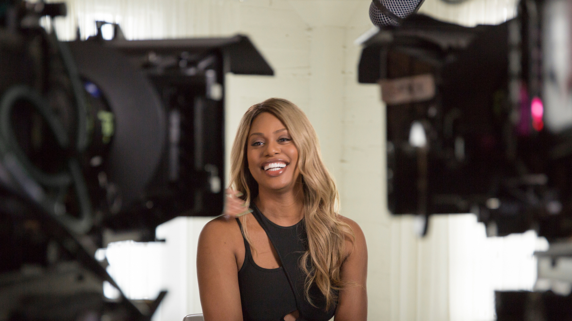 "Orange Is the New Black" star Laverne Cox laughs while being interviewed between two cameras in the documentary "Disclosure"