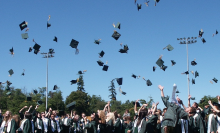 graduates throwing their caps into the air