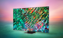Samsung QLED TV with abstract water screensaver on green and pink gradient background