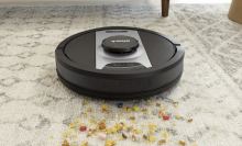 robot vacuum picking up cereal on a rug