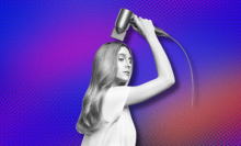 A woman holding up the Dyson Supersonic Origin to her long, flowing, light blonde locks, overlaid on a purple-orange background.