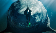 Still from Meg 2: The Trench film of a scuba diver and a shark