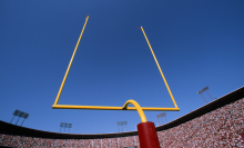 view from behind goal post in football stadium