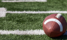 close up of football laying on football field