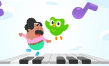 Duolingo with green bird flying over piano