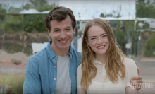 Nathan Fielder and Emma Stone standing next to each other and smiling at the camera in "The Curse."
