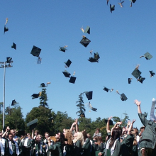 graduates throwing their caps into the air