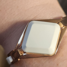 white diamond shaped screenless fitness tracker bracelet