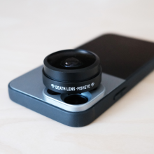 fisheye lens sitting overtop iphone back camera lenses