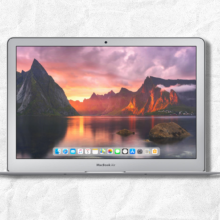 refurbished macbook air with screen open and white textured background