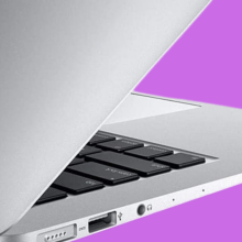 The 2017 MacBook Air positioned sideways, overlaid on a pinkish-purple background.