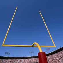 view from behind goal post in football stadium